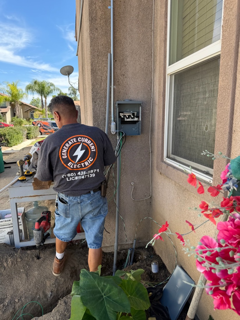 Generate Current Electric technician working on an exterior electrical panel