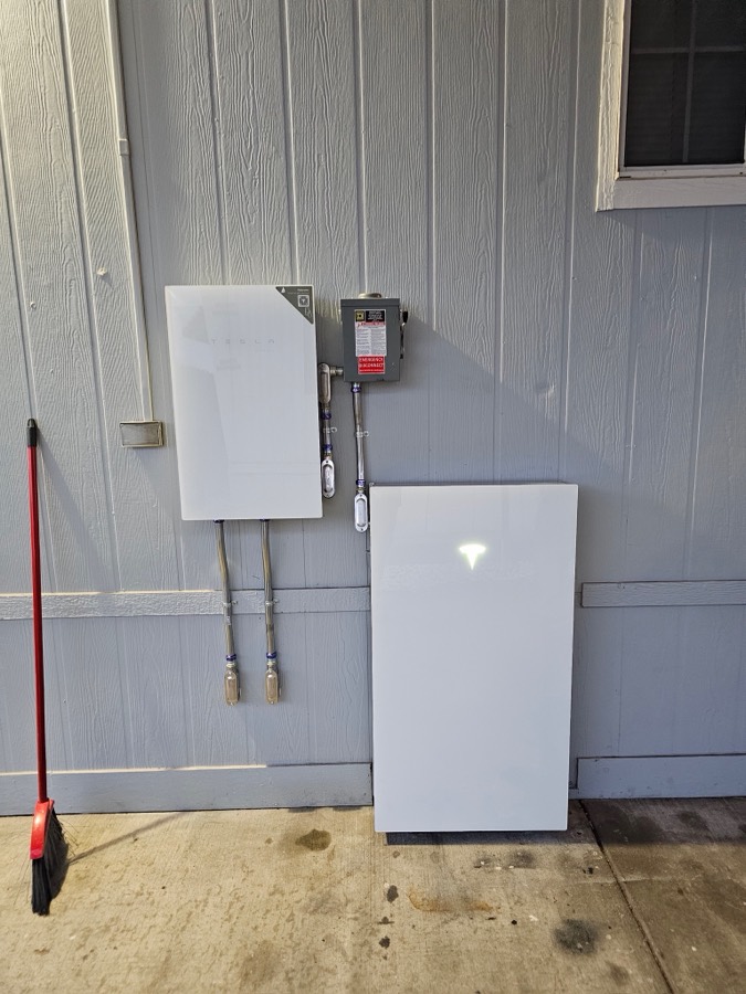 Home battery backup system mounted in a garage
