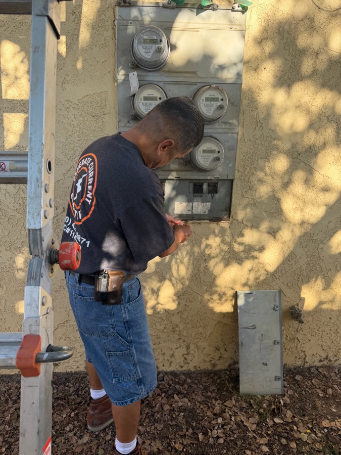 Electrician diagnosing a meter bank